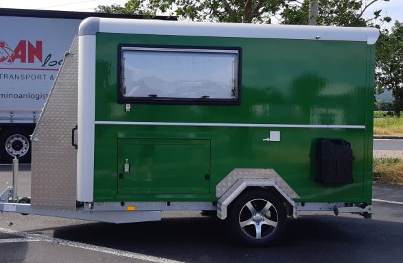 Luik ruime berging Groene caravan op maat gemaakt van een gesloten aanhanger met metalen afwerking en ramen en een bergluik aan de zijkant.